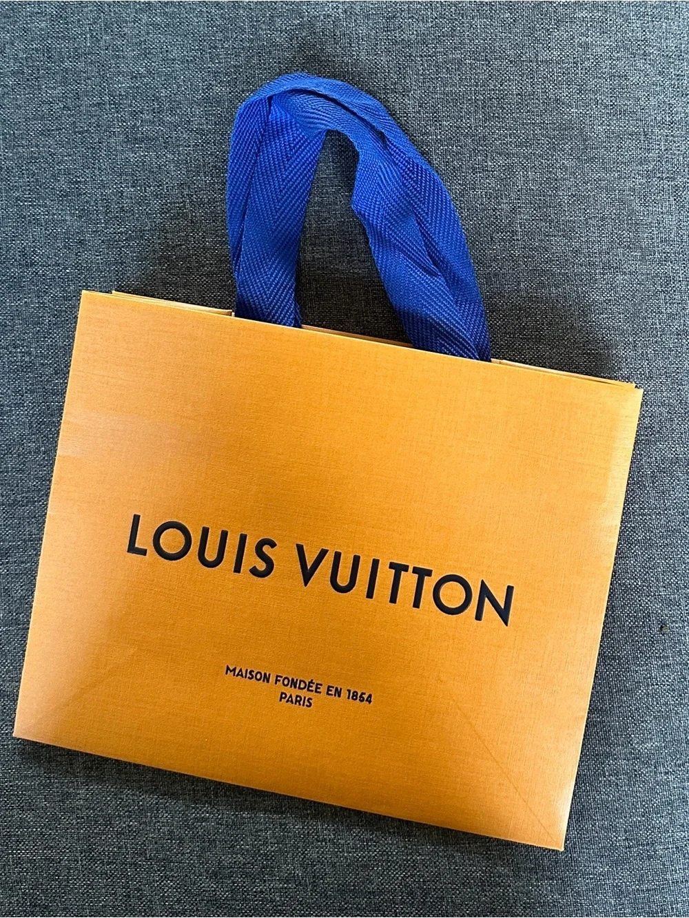 Louis Vuitton Orange Shopping Bag with Blue Handles and Black Logo
